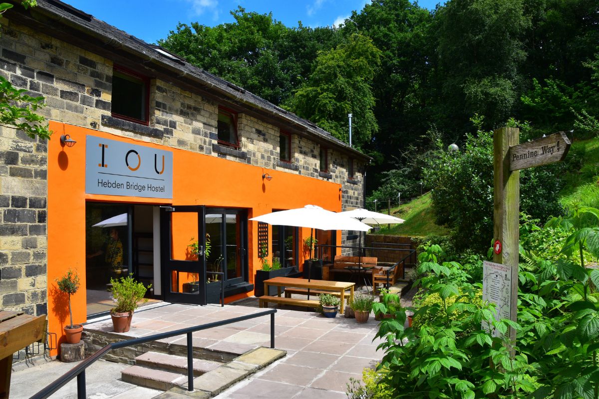 Large building set in gardens with bright orange painted entrance